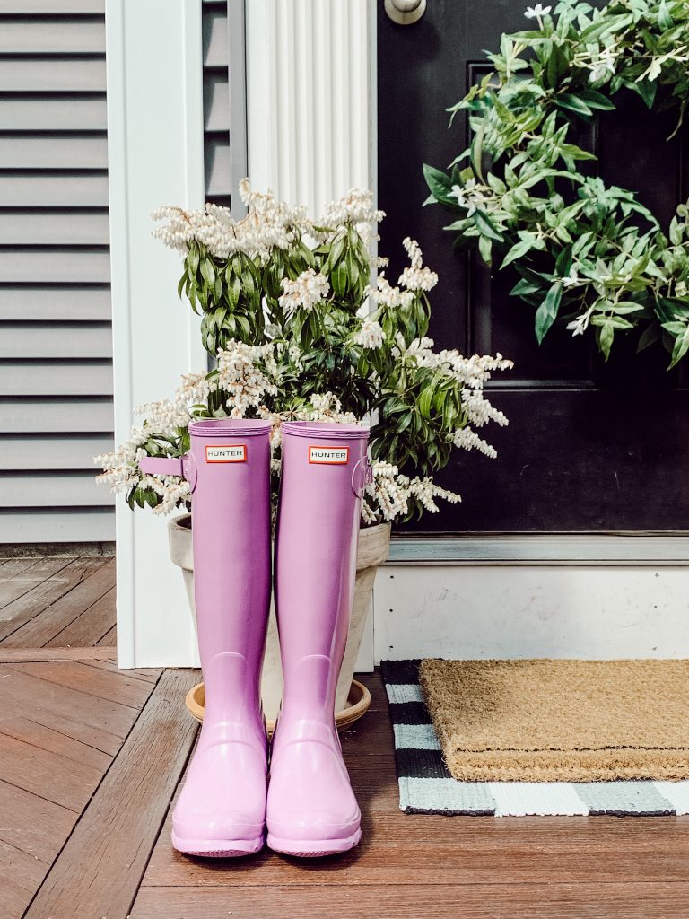 Home spring refresh ideas include updating the wreath on your front door and adding a new doormat.