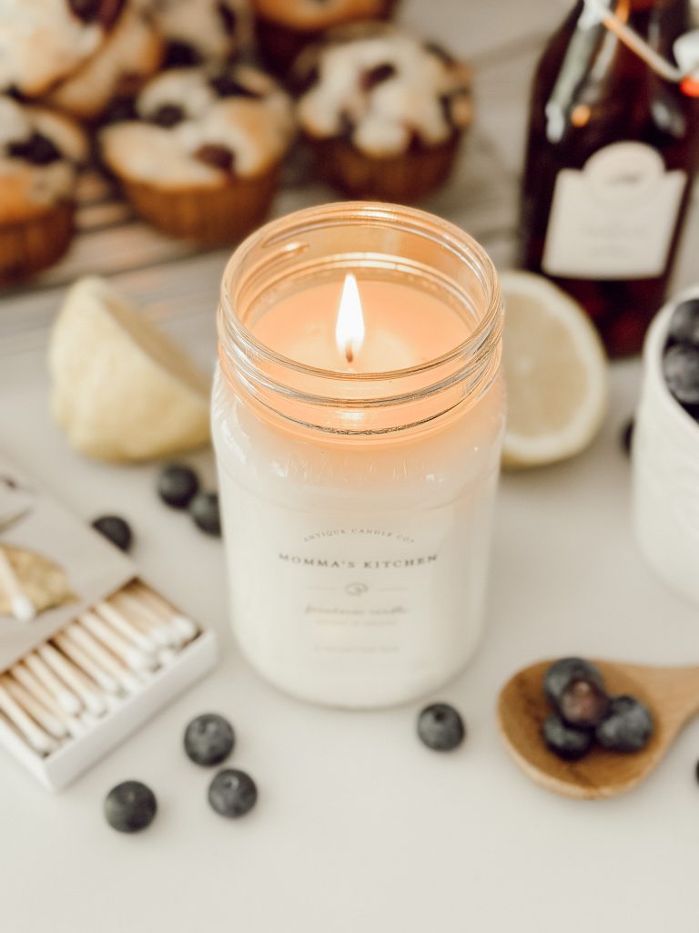 Spring scented candle with lemon blueberry muffins in the kitchen to create cozy home decor.