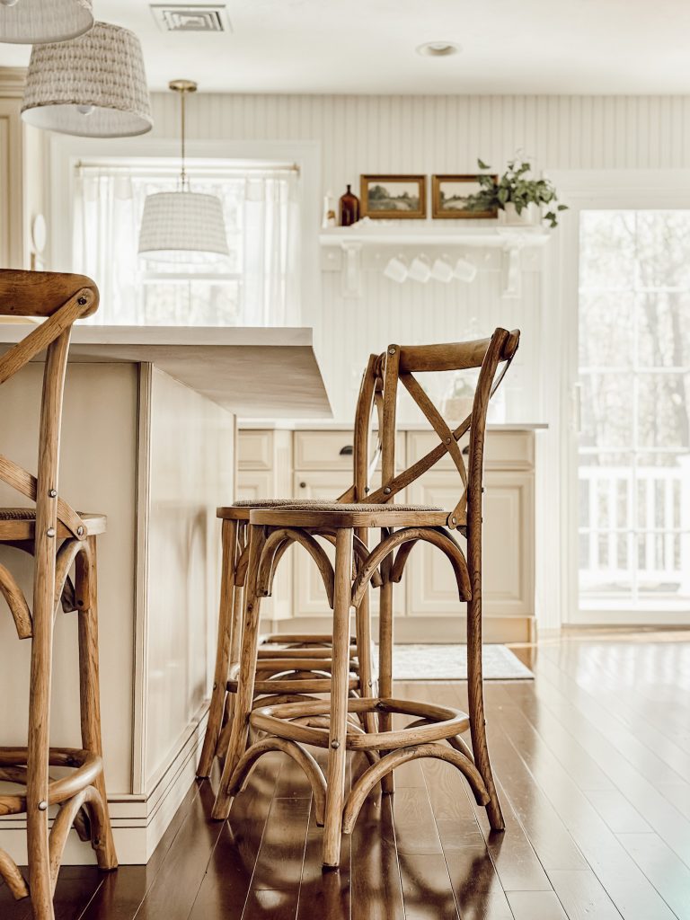 Wooden cross back counter stools at the kitchen island in the heart of the home.
