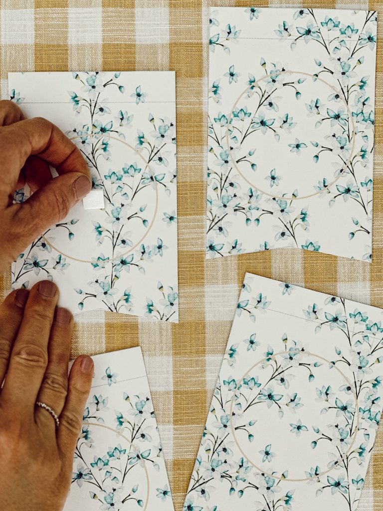 Attach foam stickers to the center of the paper pennants to attach the circular shapes to.