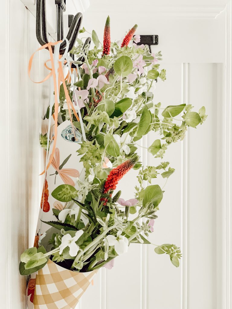 Easy small baskets hanging on hooks for first of May springtime celebrations.