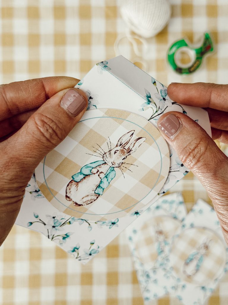 Fold over the top flap of the cardstock pennant to hang it to the kitchen twine.