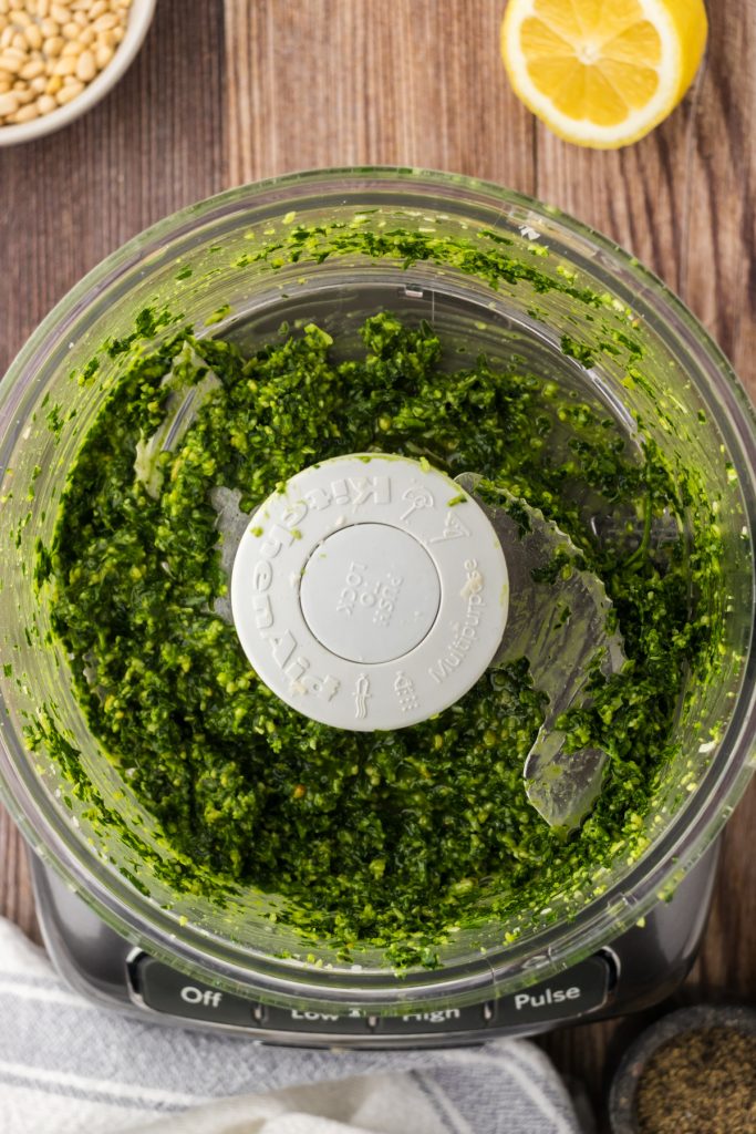 All of the ingredients combined to make a great pesto with flat leaf parsley, pine nuts, and parmesan cheese.