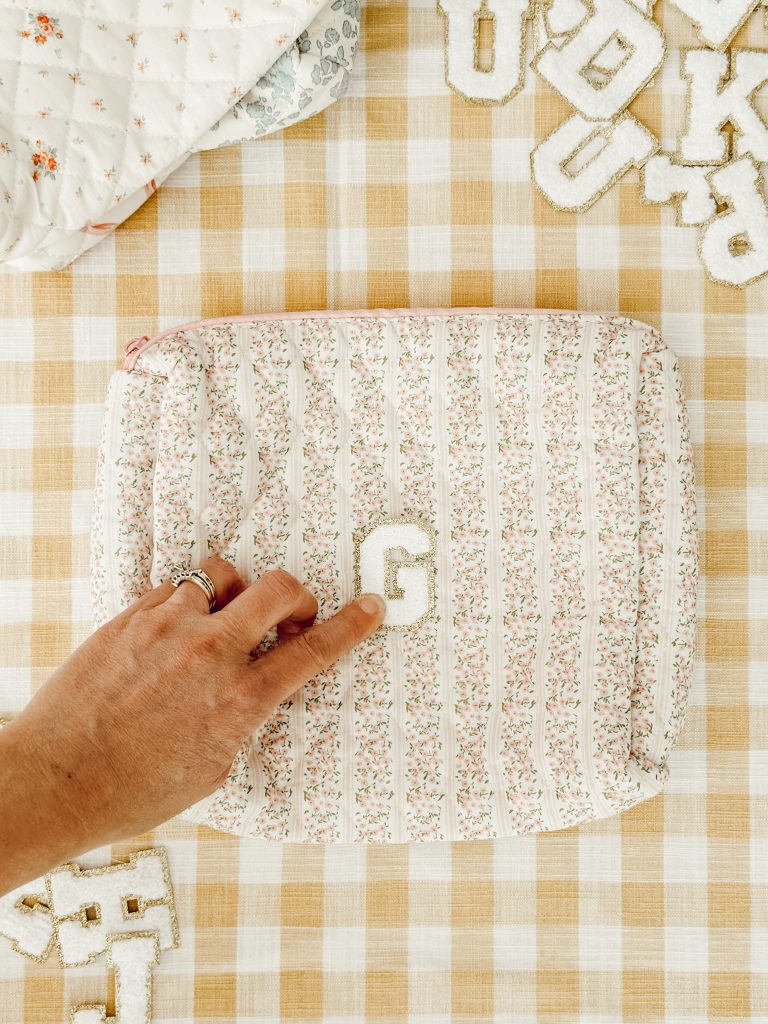 The letter "G" iron on patch in the center of the quilted pouch to make a personalized travel bag.
