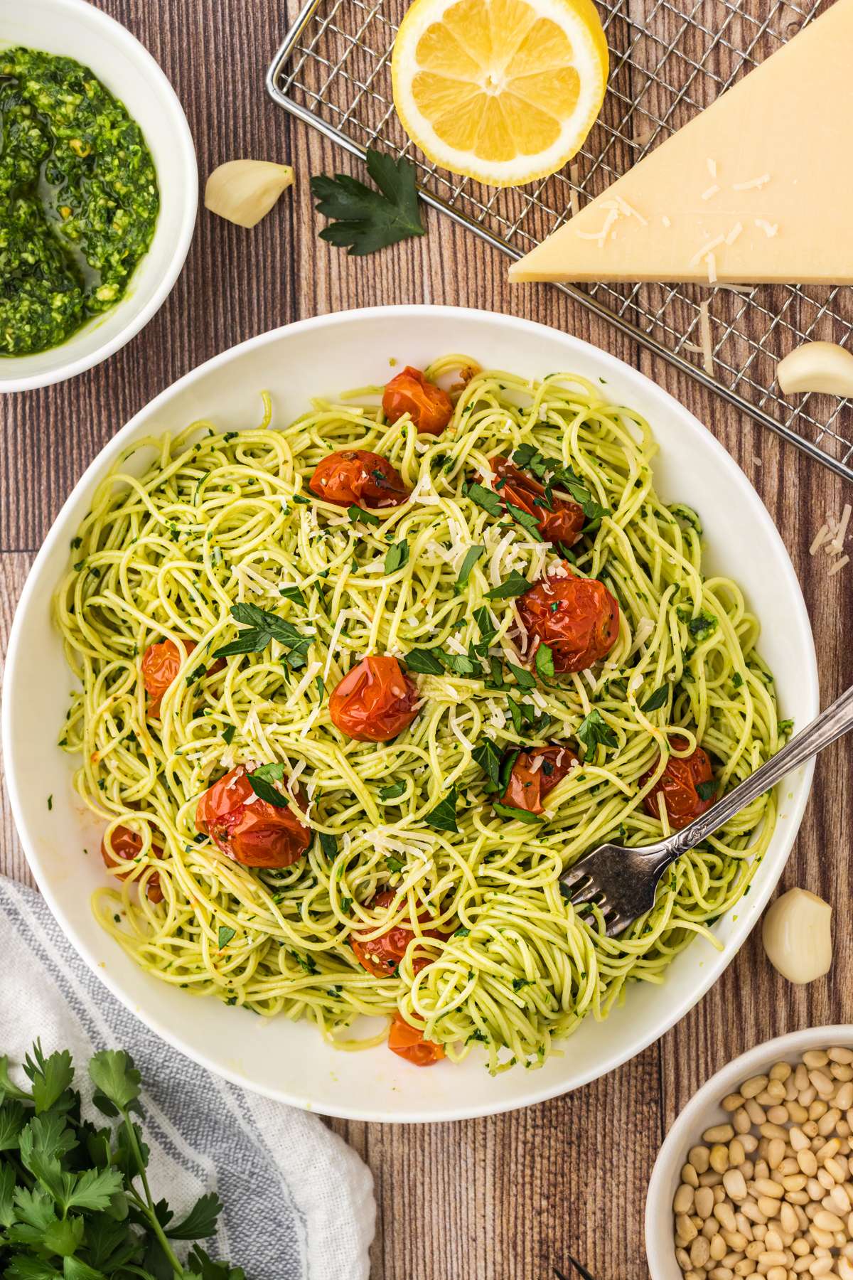 Angel hair pasta topped with parsley pesto, cherry tomatoes, and parmesan cheese. One of our favorite pasta dishes!