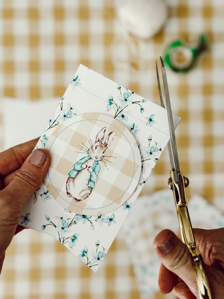 With sharp scissors, cut a triangle in the top of corner of the pennant to hide the back flap on the string.