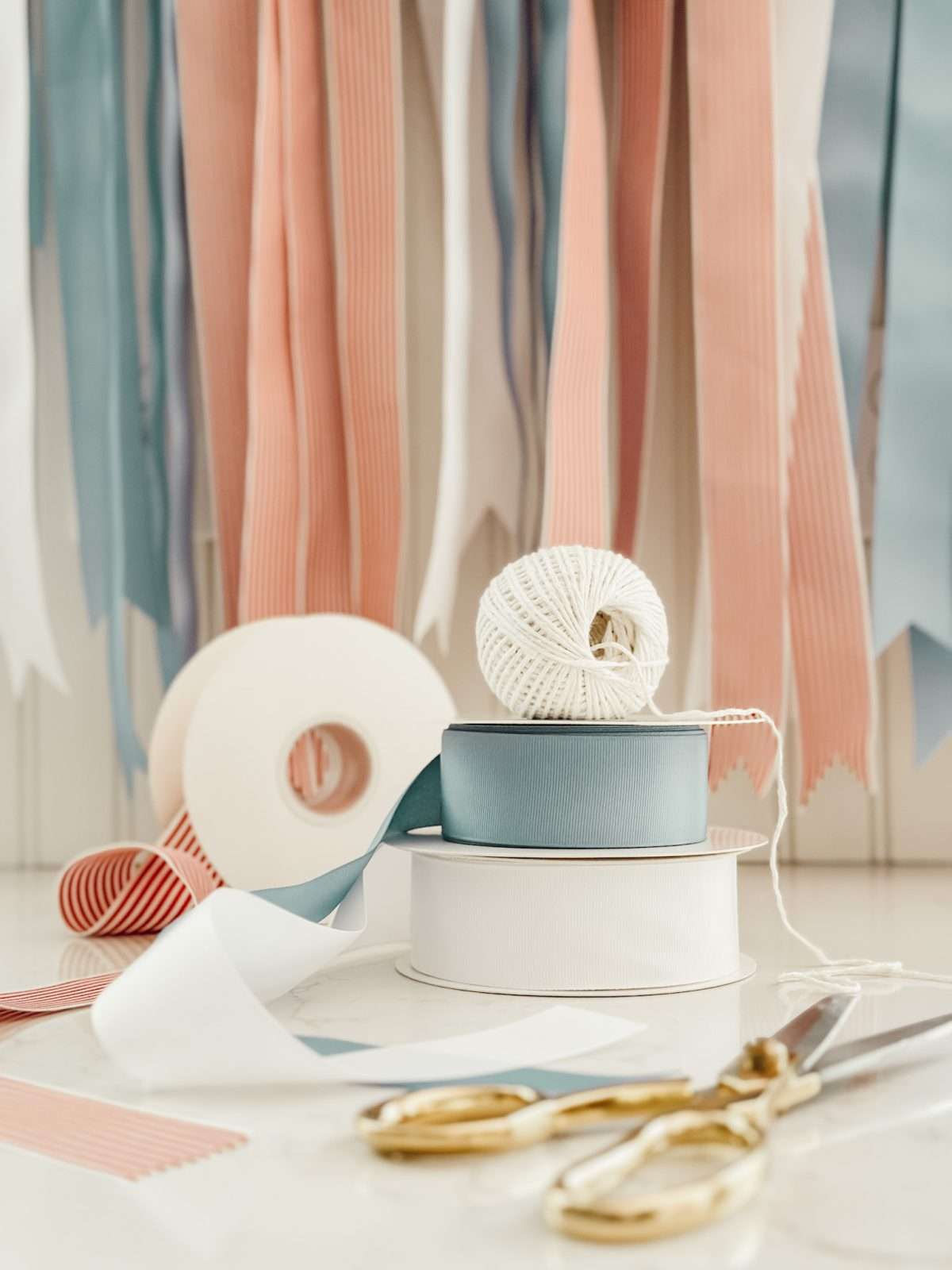 Ribbon and kitchen twine with scissors on kitchen counter to make easy DIY projects that you'll love for summer.
