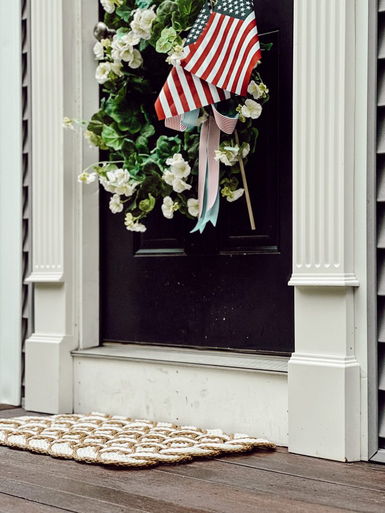Patriotic wreath hanging on front door for the summer season. 