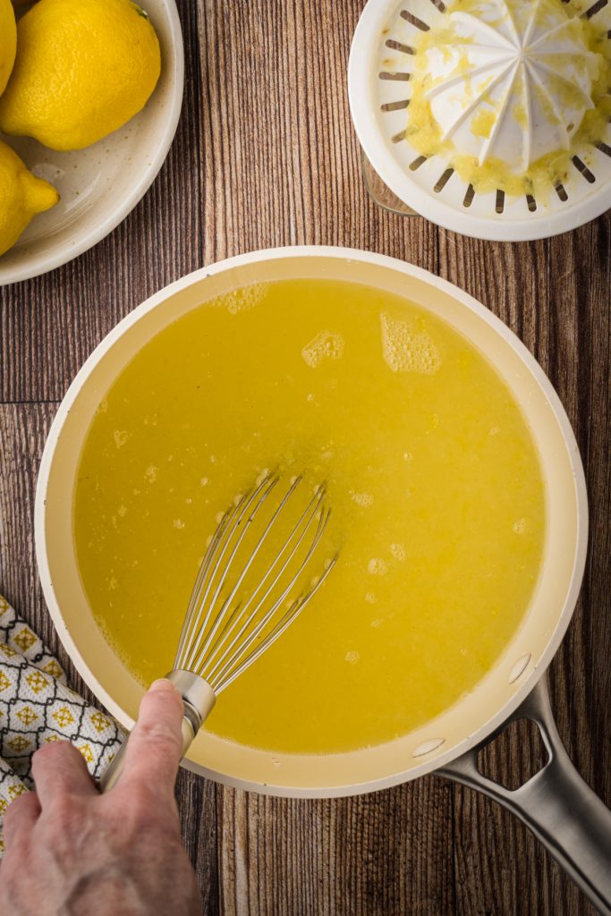 Using a whisk to combine the concentrate ingredients together.