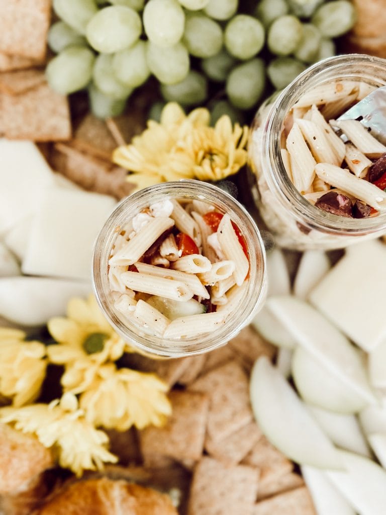 Best Italian pasta salad recipe with cherry tomatoes, cucumbers, black olives, feta cheese, and red onions.