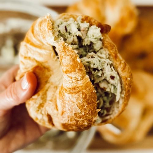 Easy avocado chicken salad on a croissant roll for a picnic.