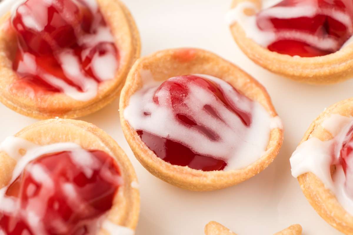 Plate of mini cherry pies that can be served at parties, holidays, or on a charcuterie board.