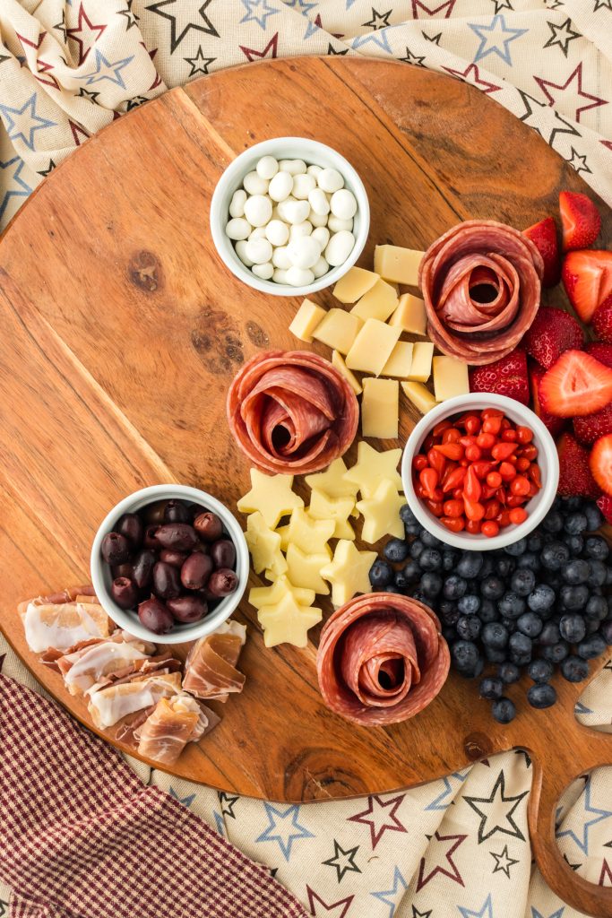 Add salami rosettes on July 4th snack board along with cheese cut out into star shapes with a cookie cutter