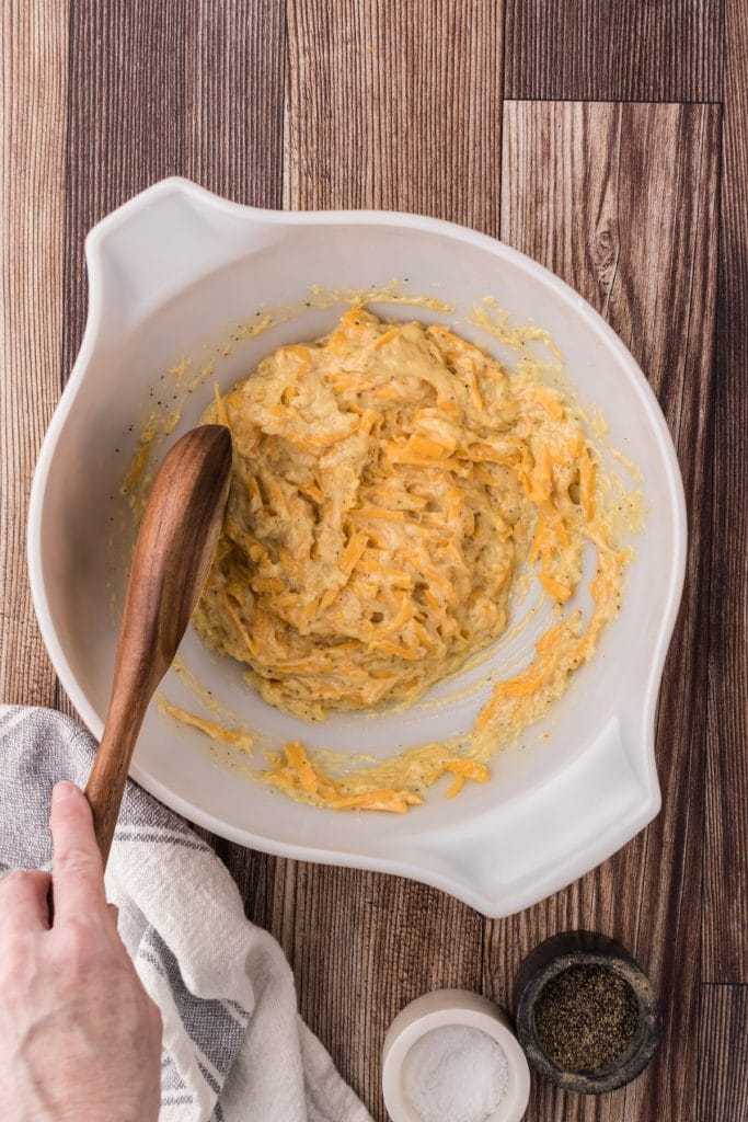 Stir the cheesy sauce together before adding the frozen hashbrown potatoes.