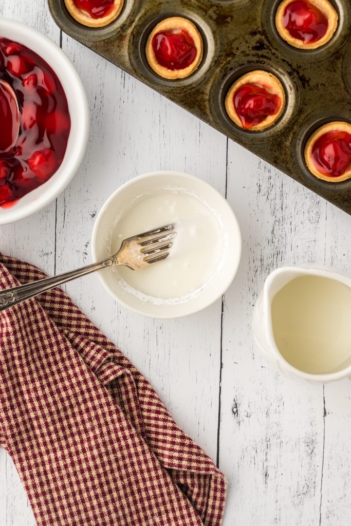 Using a fork mix the powdered sugar with the milk in a small bowl to make the glaze for the top of the pies.
