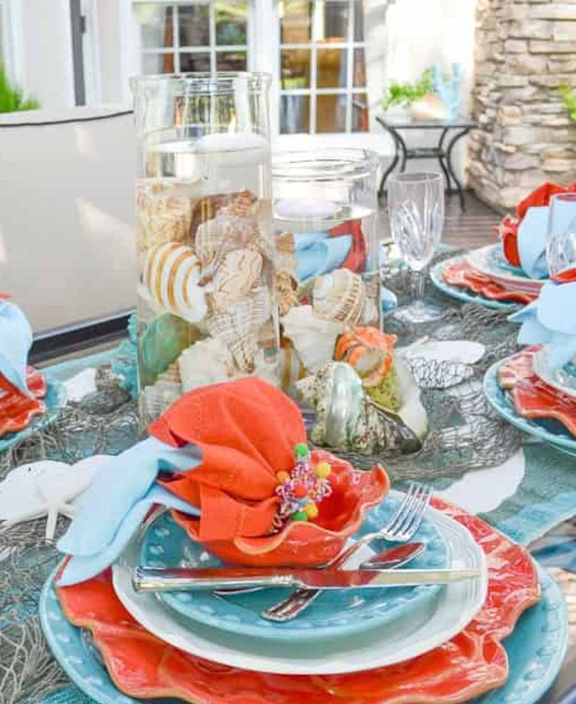 Worthing Court blog picture of a summer tablescape with bright colors and seashells.