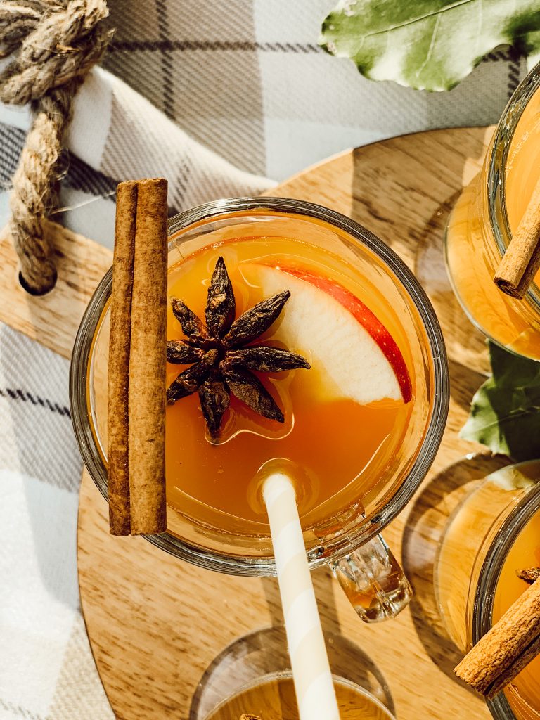 How to set up an apple cider bar with glasses of apple cider and seasonal accents.
