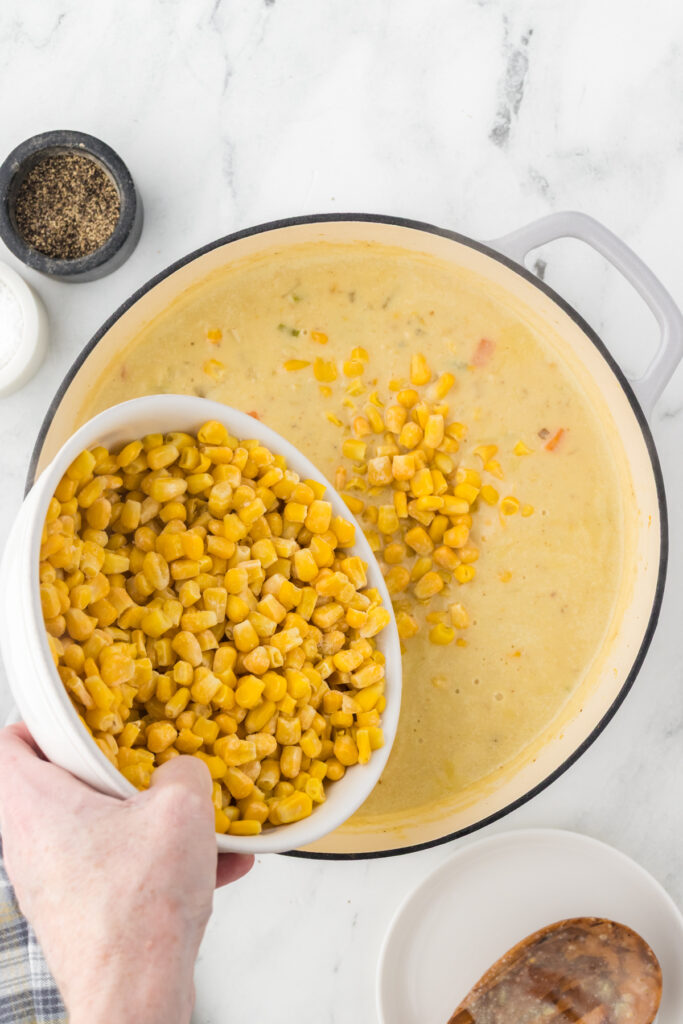 Adding fresh corn to create a delicious corn chowder.