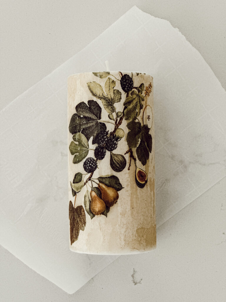 Custom DIY candle using a paper napkin to create personalized home decor.