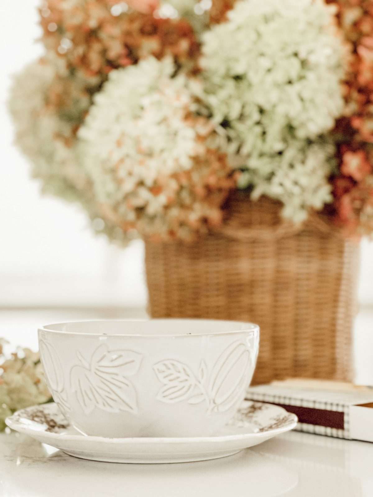 Easy ideas on how to decorate for fall using your 5 senses including a fall pumpkin candle and a basket of dried hyradrangeas.