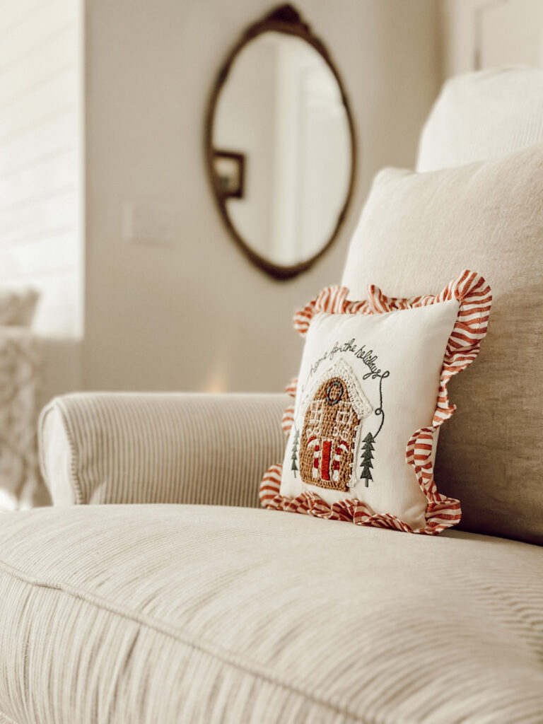 Start decorating your home for Christmas with small accents like this Home for the Holidays pillow on a living room chair.
