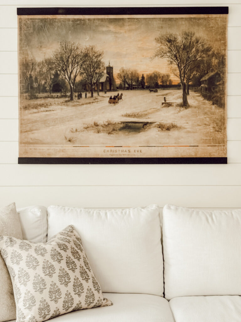 Magnolia holiday collection 2025 includes vintage inspired artwork in living room.