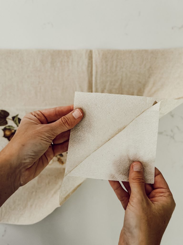 Peel the paper napkin apart to remove just the top layer of the napkin for the candle DIY.