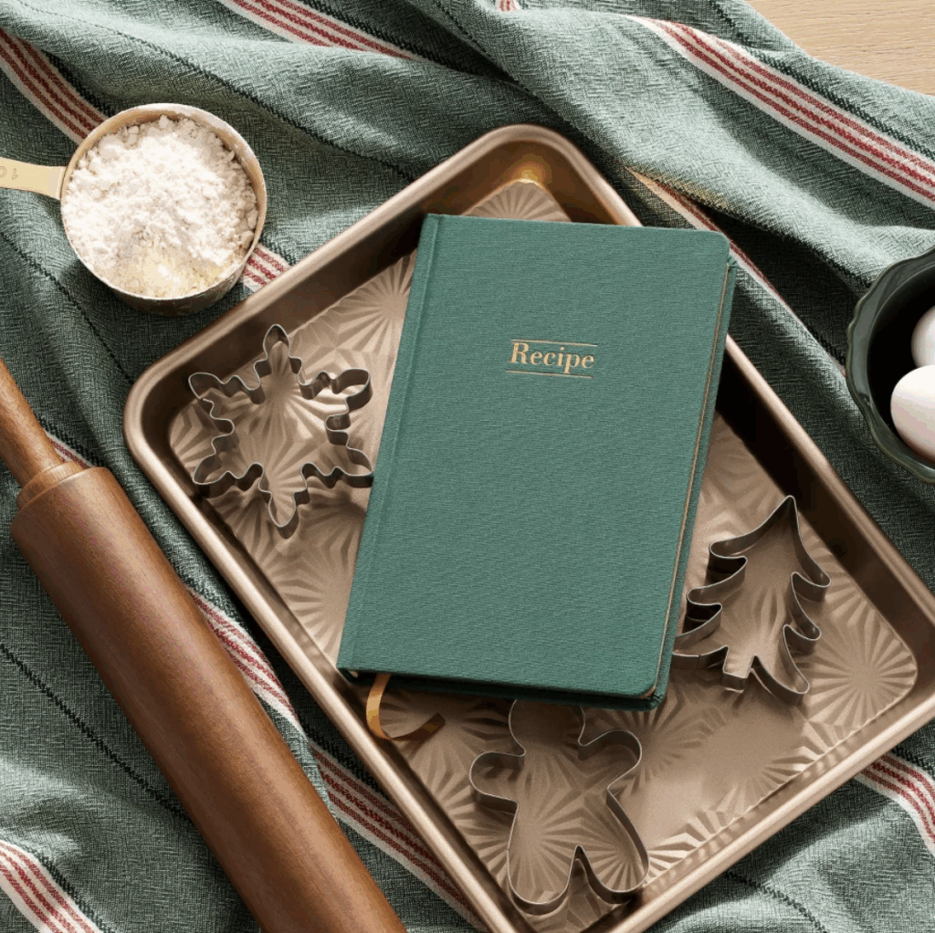 2025 Hearth and Hand Christmas release with Magnolia and Target. A recipe book with a baking sheet full of Christmas cookie cutters.