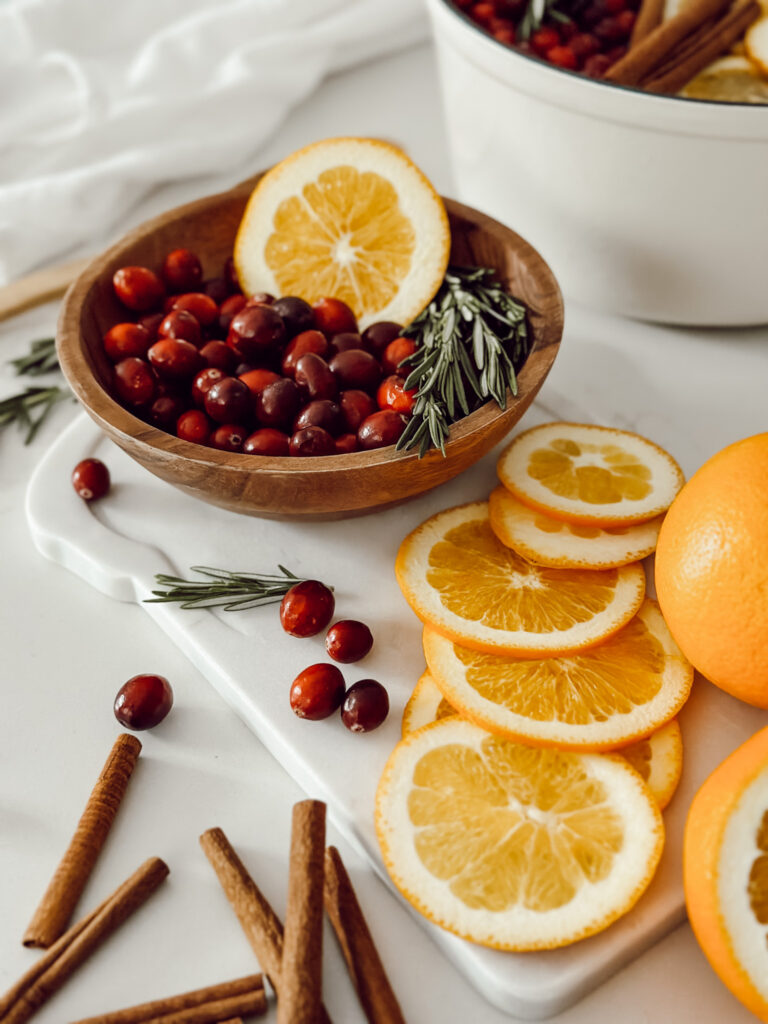 Fresh cranberries, orange slices, and cinnamon sticks to make a winter simmer pot to make the house smell like Christmas.