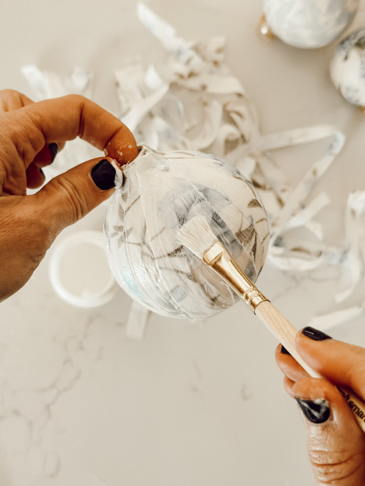 Continue to layer fabric around the circumference of the ornament to completely cover it.