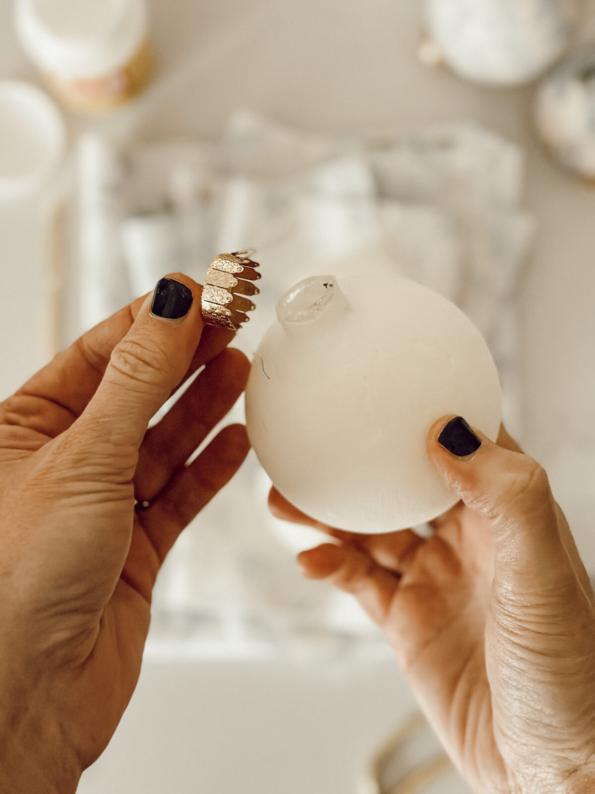 Gently remove the ornament cap to get your ornaments ready for decoupage with fabric strips and Mod Podge.