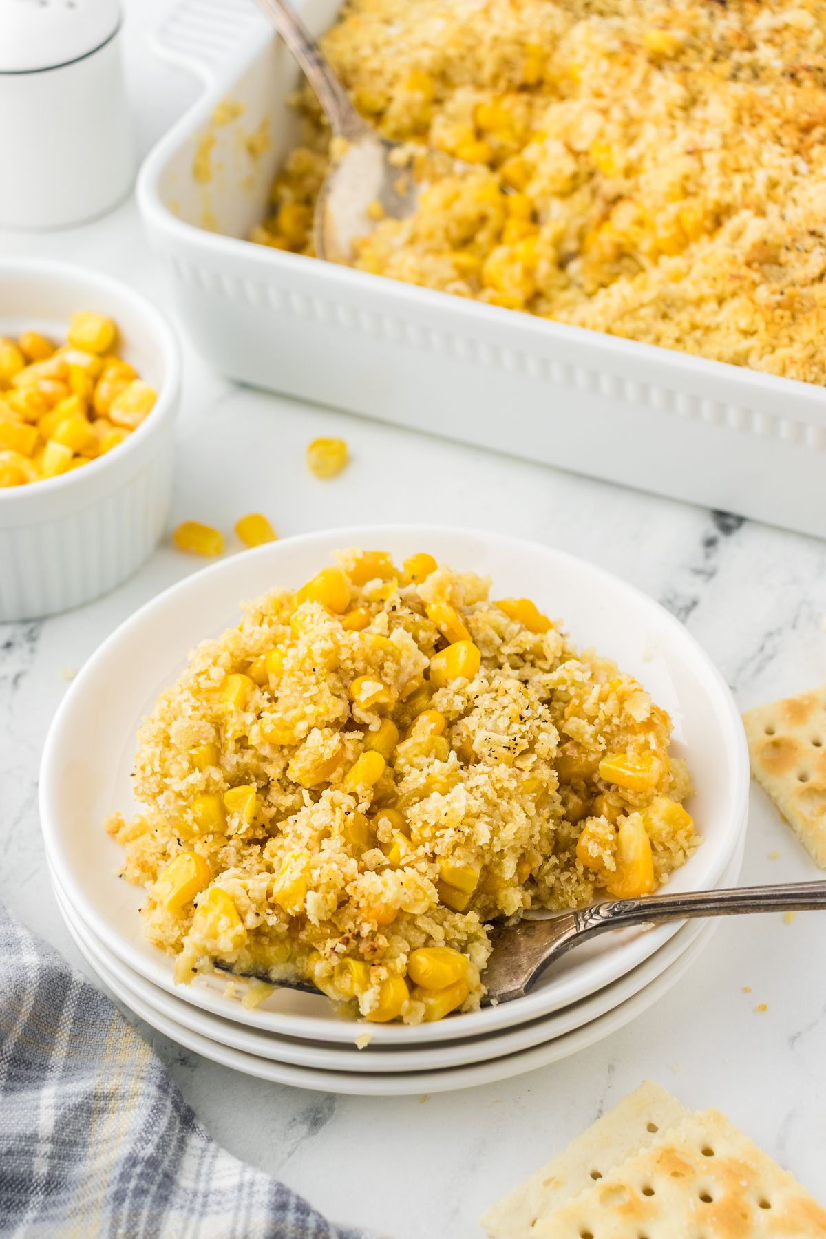 Family favorite saltine cracker creamed corn casserole with frozen corn and canned creamed corn.
