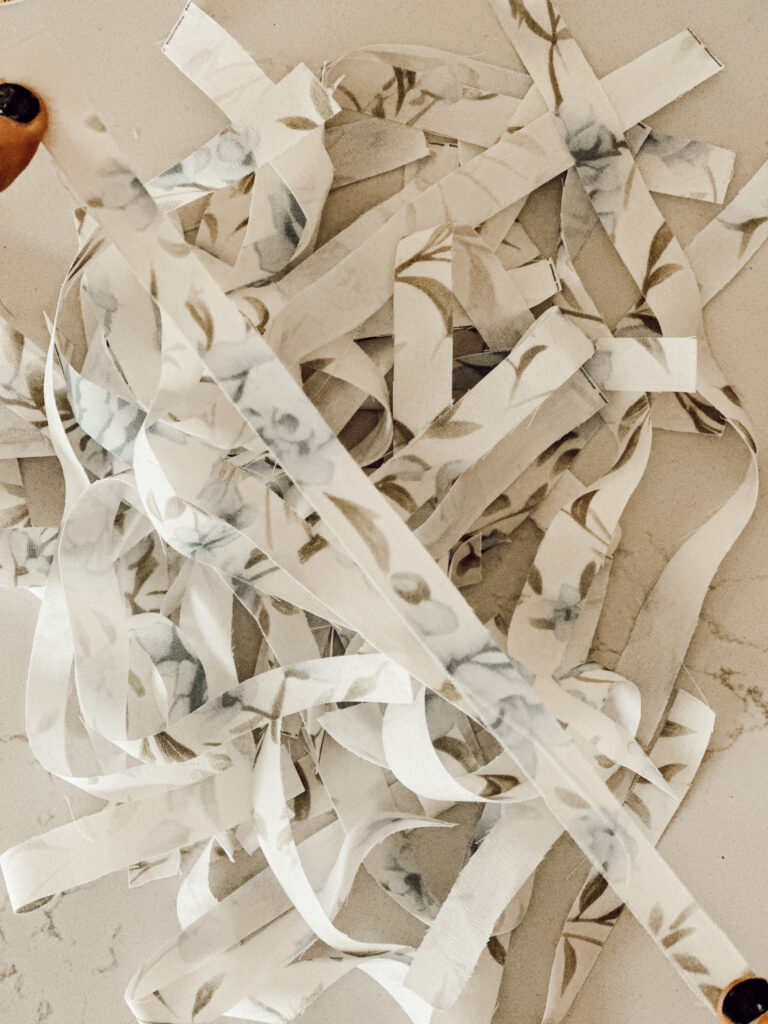 Scrap fabric cut into strips for Christmas DIY project.