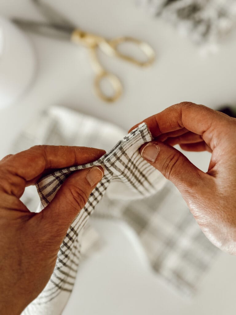 Homemade lamp shade cover with pleats out of an old tablecloth.