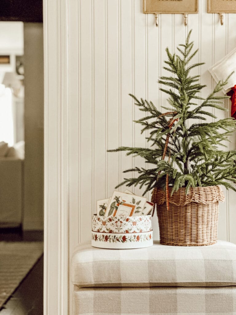 Weekly Wednesday Wish List #234 Eleanor Rose Home entryway with gingham bench, box of cards, and small evergreen tree.