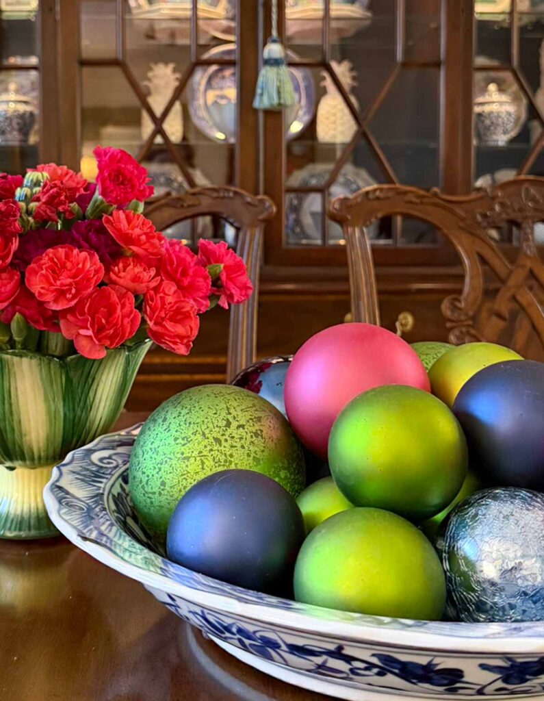 Weekly Wednesday Wish List #235 Worthing court bowl of ornaments with a vase of flowers.