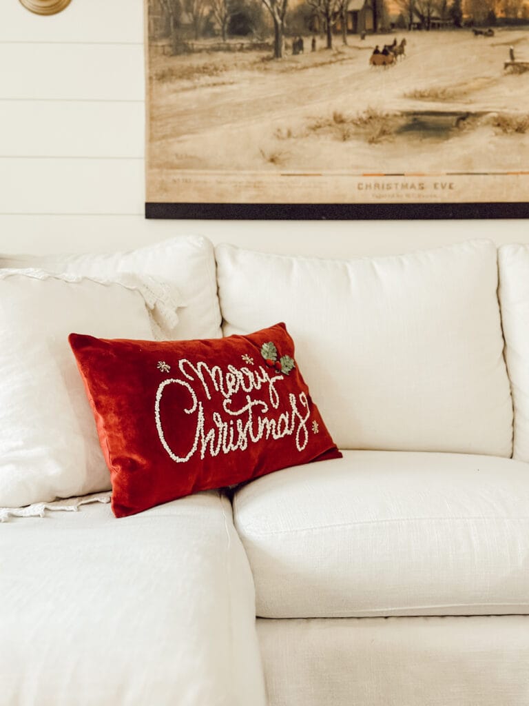 Weekly Wednesday Wish List Eleanor Rose Home couch with red Merry Christmas pillow.