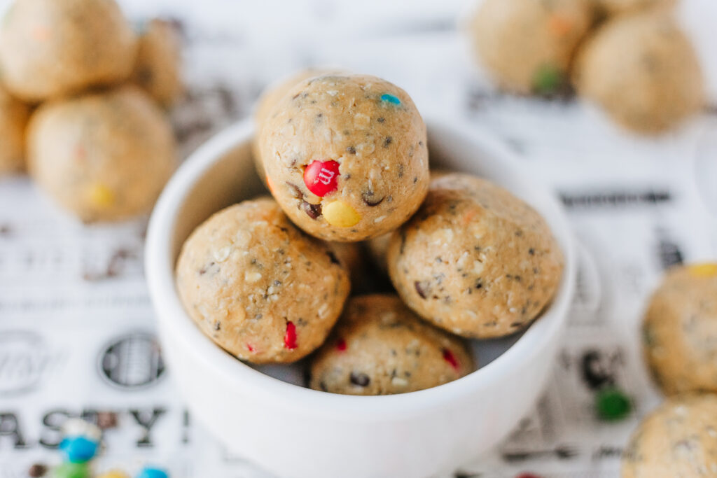 Monster cookie protein balls with mini M&Ms, oats, and mini chocolate chips.