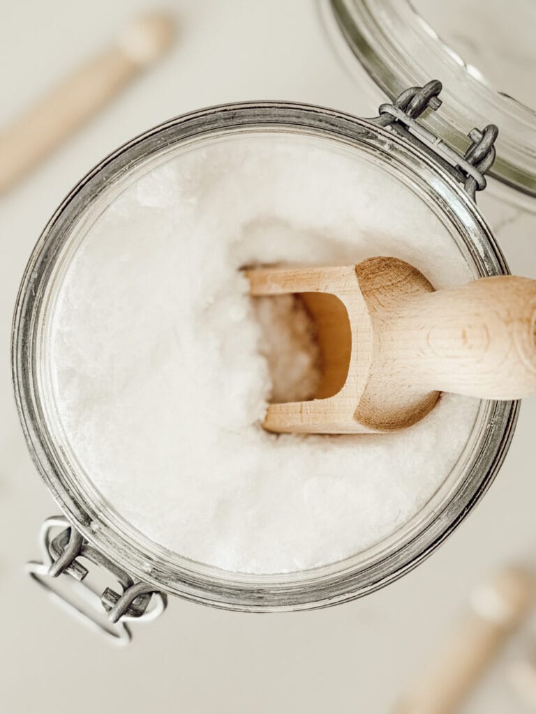 DIY natural laundry scent booster for the washing machine stored in a glass mason jar.