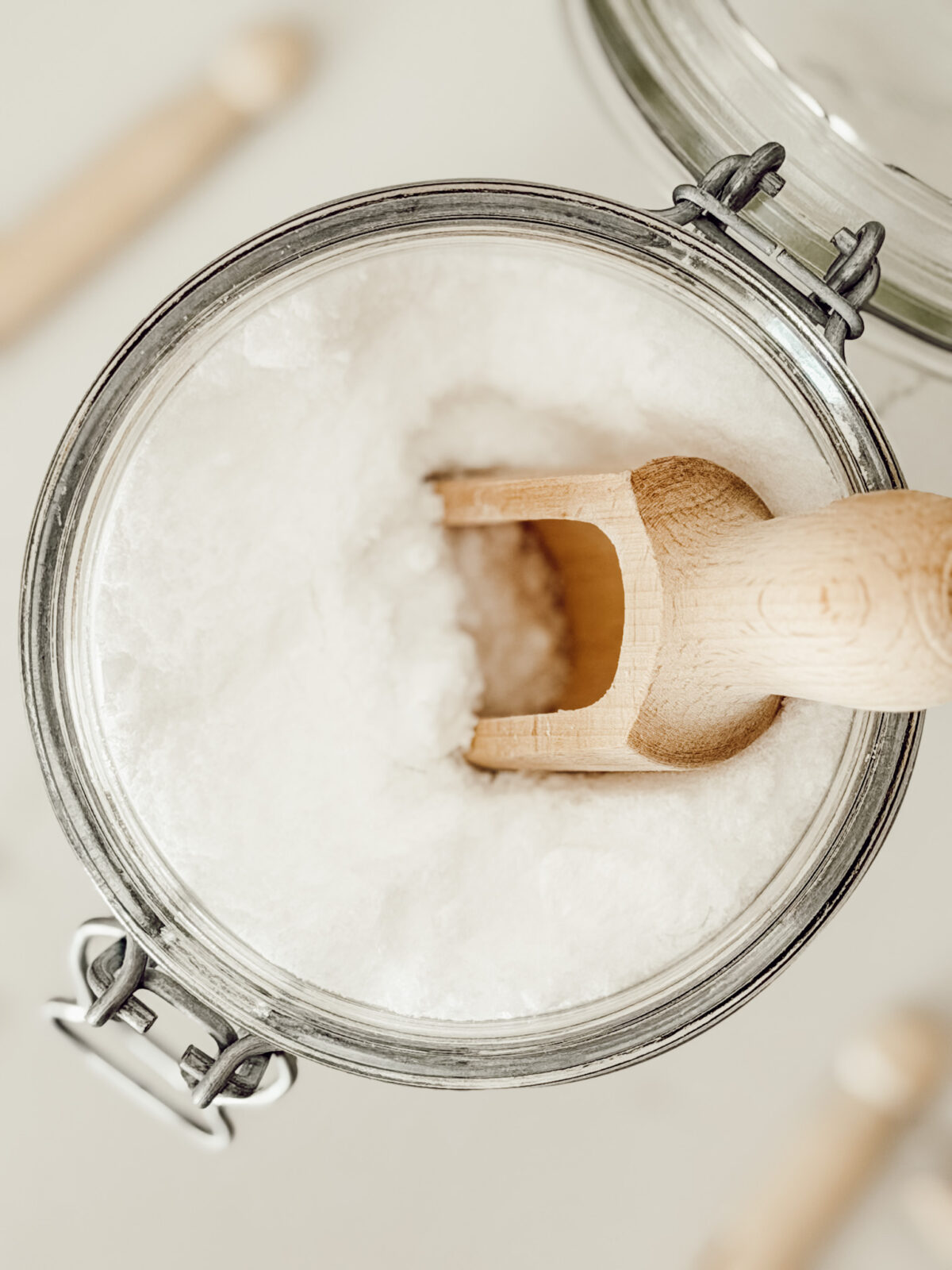 DIY natural laundry scent booster for the washing machine stored in a glass mason jar.