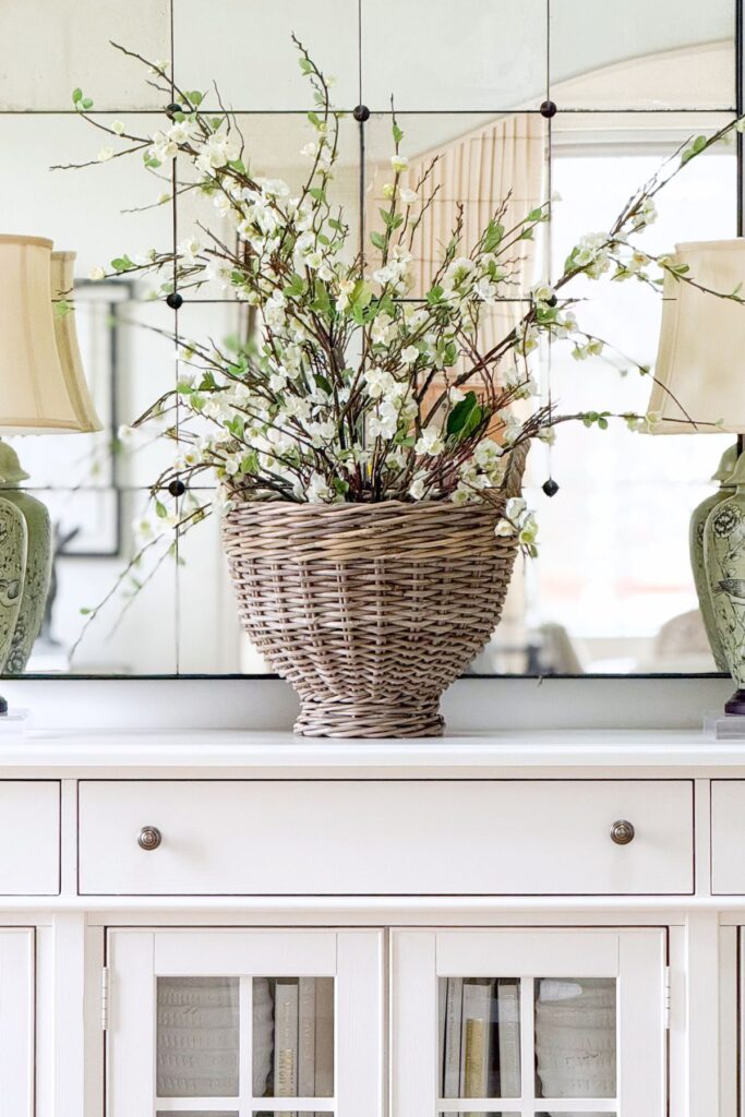Weekly Wednesday Wish List #248 StoneGable wicker vase with spring stems on console table.