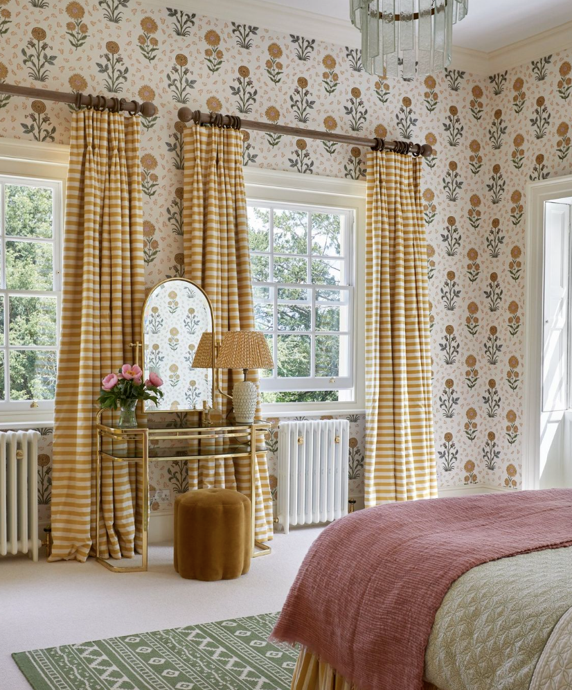 Yellow gingham curtains with block print wallpaper in a modern bedroom for a restful sleep.