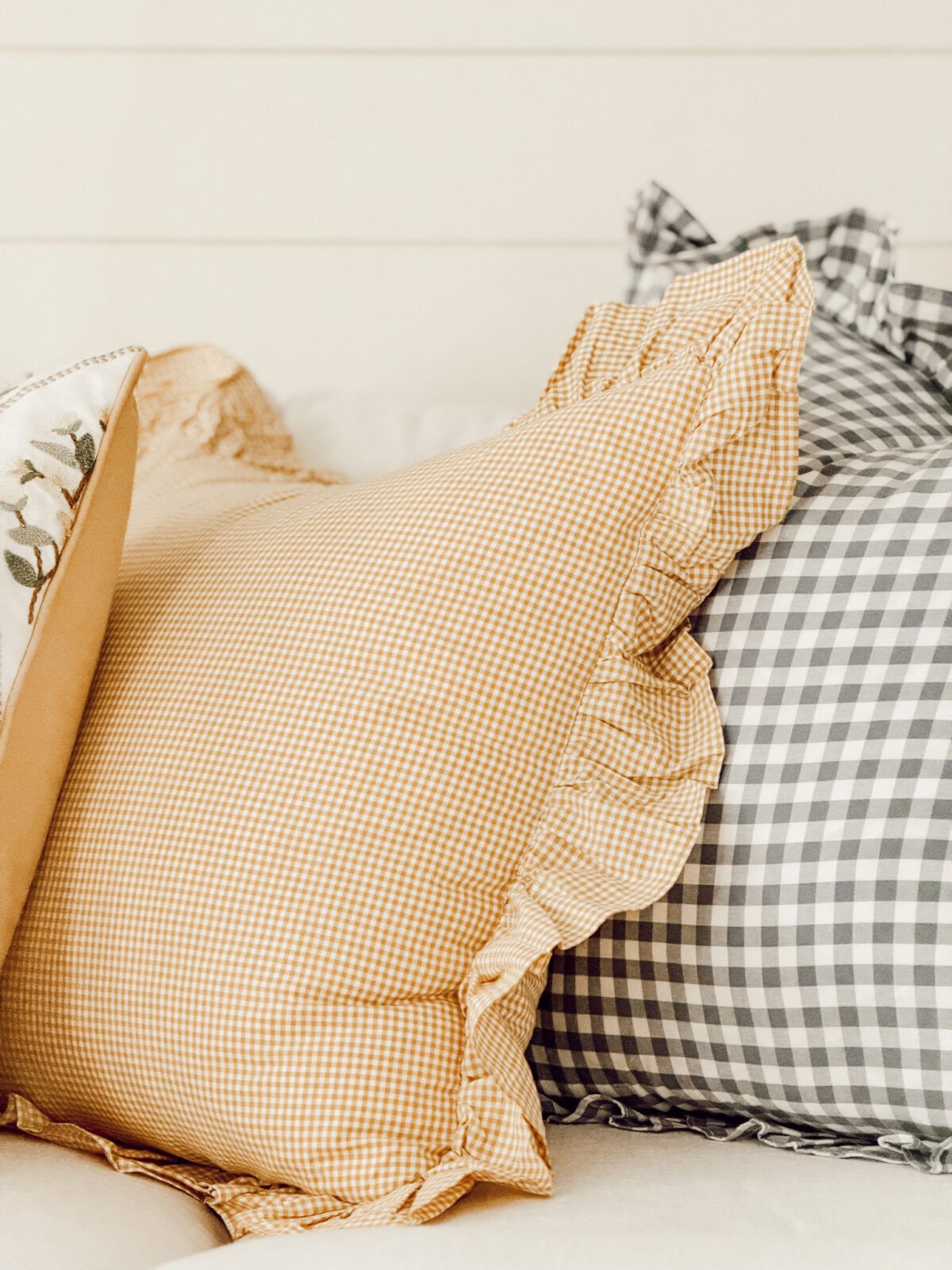 Yellow and blue gingham throw pillows on the couch.