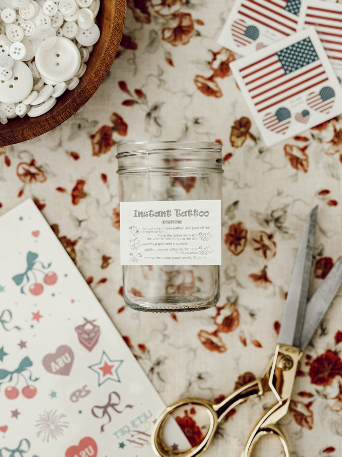 Place the temporary tattoo on the glass jar and press down with a white rag or sponge to adhere the temporary tattoo to the glass.