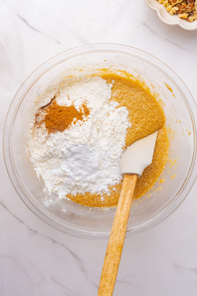 Mixing the dry ingredients into the wet ingredients with a rubber spatula.