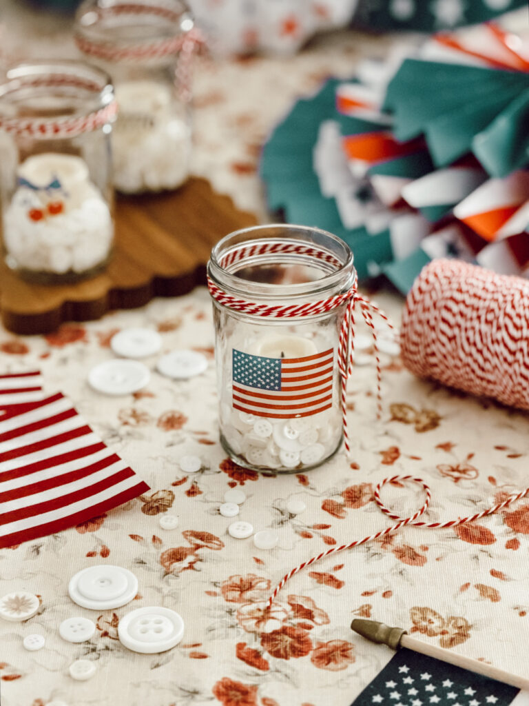 Americana votive candles made with temporary tattoos, white buttons, and kitchen twine.