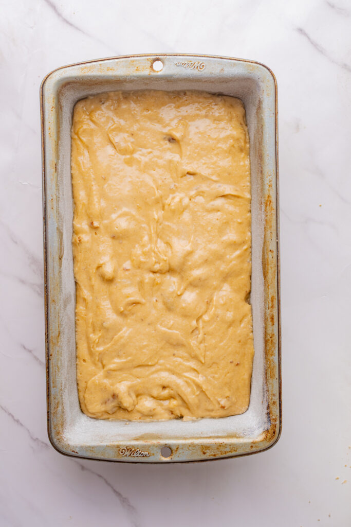Maple walnut coffee cake batter in a metal loaf pan.