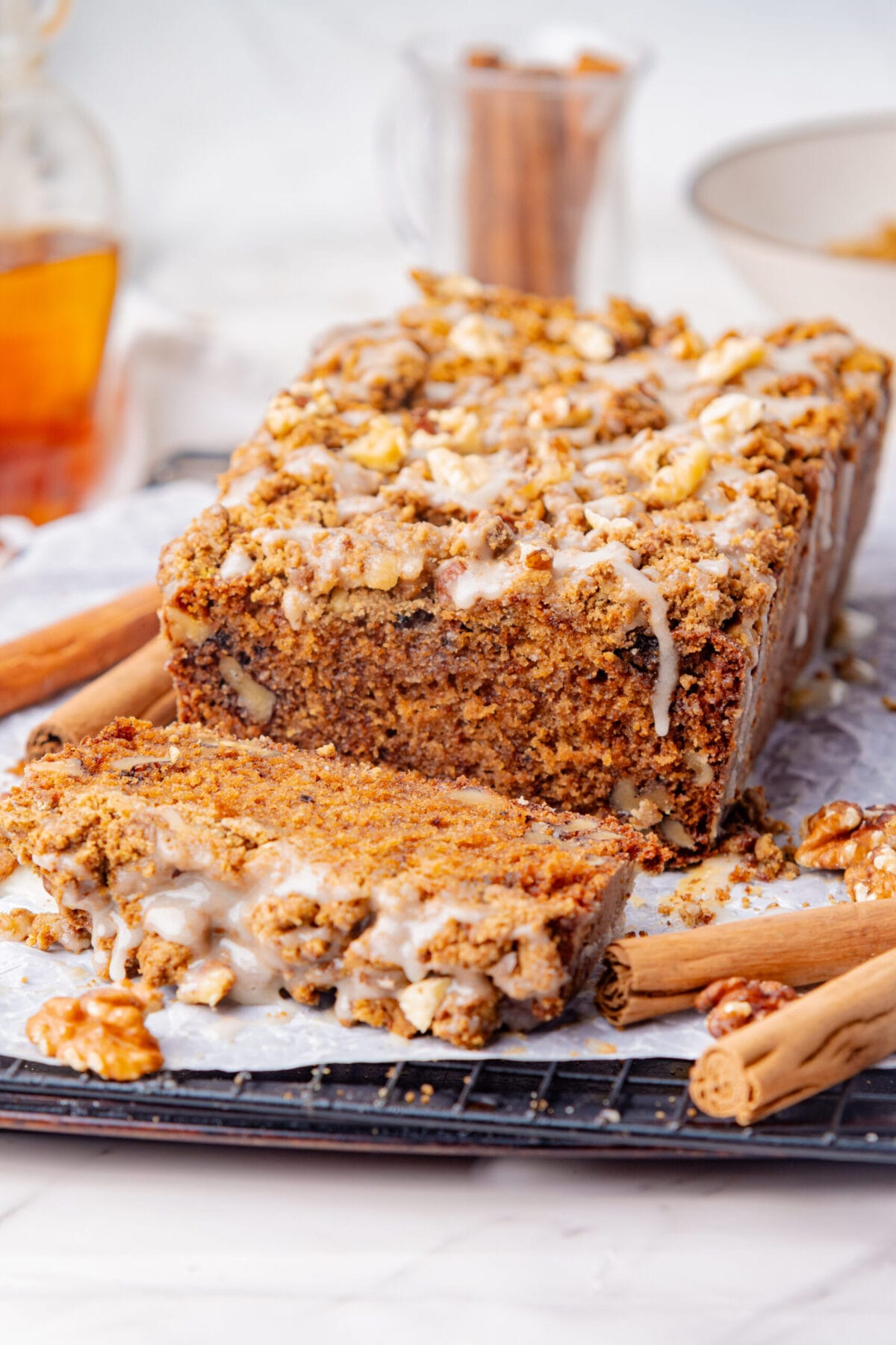 Maple walnut coffee cake loaf with maple streusel and powdered sugar glaze.