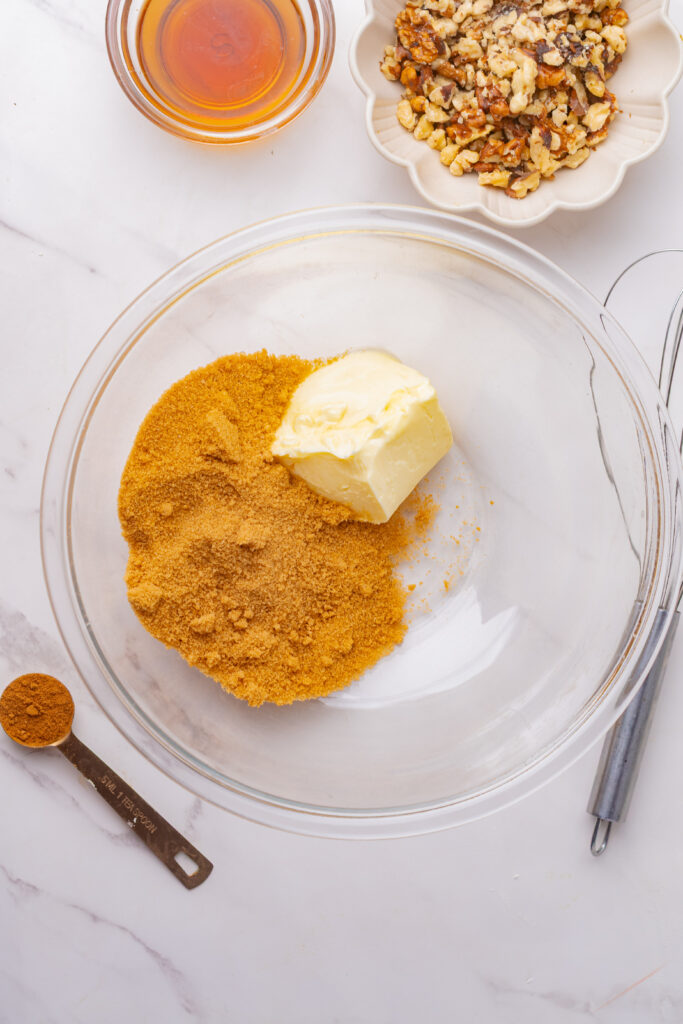 Softened salted butter and brown sugar in a mixing bowl to make coffee cake batter.