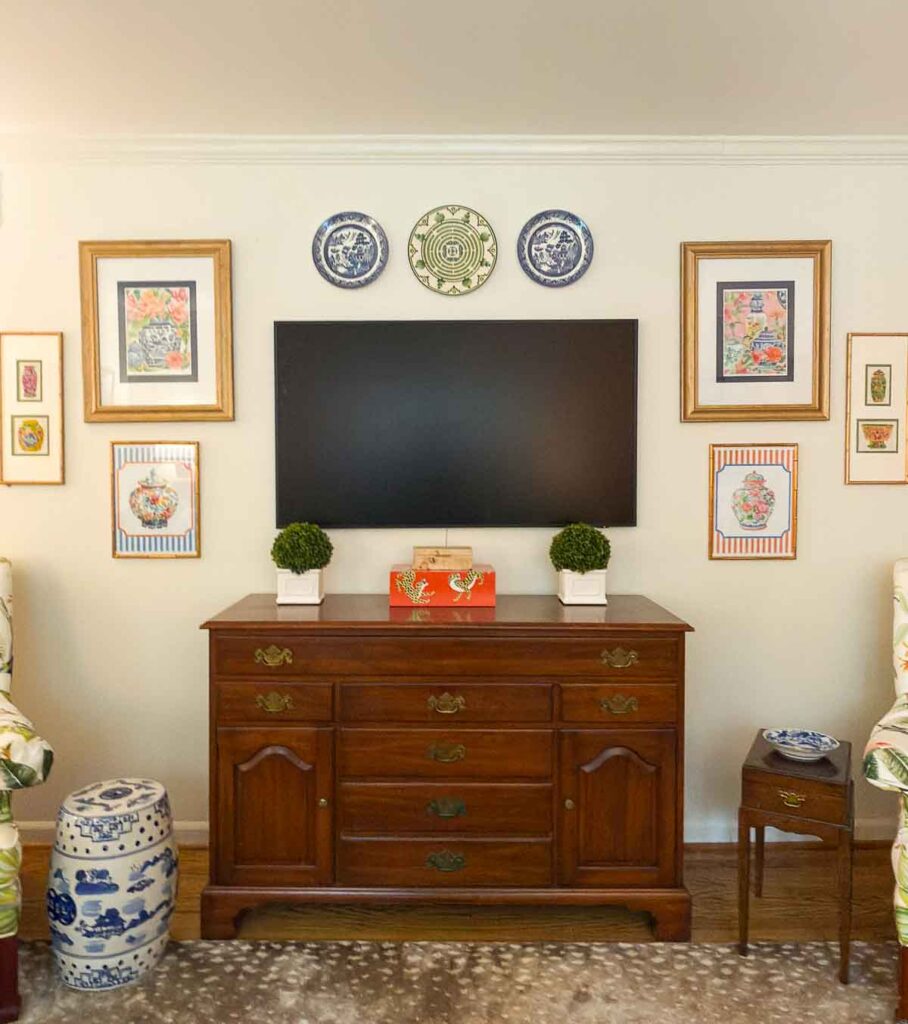 Weekly Wednesday Wish List Worthing Court living room with a dresser and tv mounted on the wall.